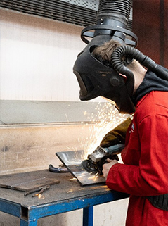 welding apprentice using grinder