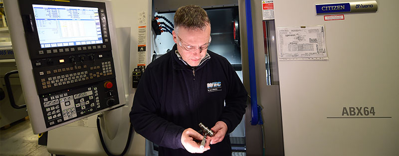 WEC Machining Precision Engineer inspecting component produced on new Citizen Miyano machine